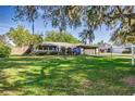 Inviting home with a well-kept lawn and a charming entrance featuring a red door at 115 W Christina Blvd, Lakeland, FL 33813