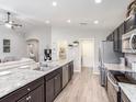 Spacious kitchen featuring dark cabinets, stainless steel appliances, granite countertops, and an open layout at 1752 Burrows Ave, Lakeland, FL 33811