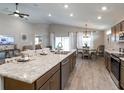 Open kitchen with modern appliances, a large island, and seamless flow into the dining area at 1758 Burrows Ave, Lakeland, FL 33811