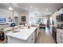 Spacious kitchen features an island with seating, stainless steel appliances and open to the dining area at 1794 Daystar Dr, Haines City, FL 33844