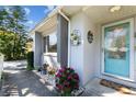 Charming front entrance with a bright door, decorative plants, and stone landscaping details at 2020 Indian Trl, Lakeland, FL 33813