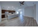 Open-concept living room and kitchen featuring modern floors and plenty of natural light at 236 Talladega Ln, Polk City, FL 33868