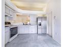 Bright kitchen with white appliances, cabinets, tile flooring, and ample counter space at 2613 Sundance Cir, Mulberry, FL 33860