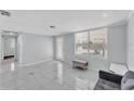 Inviting living room with tile flooring, neutral paint, and large windows at 3995 Townley Dr, Mulberry, FL 33860