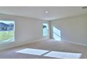 Sun-drenched bedroom featuring plush carpeting and double windows at 4062 Tullamore Ln, Auburndale, FL 33823