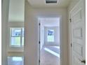 Bright hallway leads to sunlit rooms, enhancing the home's airy feel at 4062 Tullamore Ln, Auburndale, FL 33823