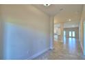 Open-concept foyer featuring neutral walls, tile flooring, and clear sightlines to other living areas at 4123 Tullamore Ln, Auburndale, FL 33823