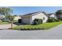 Home exterior featuring a manicured lawn and a brick-paved driveway leading to the garage at 4315 Larrys Lagoon, Winter Haven, FL 33884