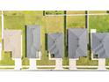 Aerial view of rooftops, manicured lawns, and driveways showcases a well-planned residential community at 4424 Reding Way, Lakeland, FL 33813