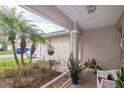 Covered front porch with a seating area and views of the landscaped yard at 4427 Whistlewood Cir, Lakeland, FL 33811