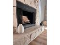 Close-up of a stone fireplace with mantle, hearth, and decorative accessories at 4641 Devon Ave, Lakeland, FL 33813