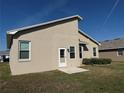 Home exterior showing the back of the home featuring a door to the backyard at 6059 Swallow Dr, Lakeland, FL 33809