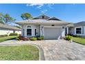 Beautiful single-story home with an attached garage and well-manicured lawn at 6217 Peacock Run, Lakeland, FL 33809