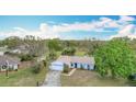 An aerial view of a blue single Gathering home with a large yard at 6305 Tocobega Dr, Lakeland, FL 33813