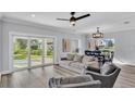 Inviting living room with sliding glass doors, wood flooring, a dining area and comfortable seating at 6421 Highlands Oak Trl, Lakeland, FL 33813