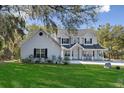 Charming two-story home with manicured lawn and inviting front porch; traditional architecture at 6810 Crystal Beach Rd, Winter Haven, FL 33880