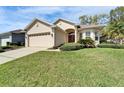 Charming single-story home with manicured lawn, two-car garage, and welcoming front entrance at 6907 Eagle Ridge Blvd, Lakeland, FL 33813