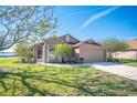 Beautiful home showcasing its landscaped front yard and welcoming entrance on a clear day at 701 Reflections Dr, Winter Haven, FL 33884