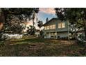 Expansive backyard featuring a covered porch, mature trees, and an inviting fire pit at 723 W Patterson St, Lakeland, FL 33803