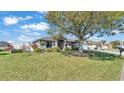 Well-maintained home with lush landscaping, a spacious lawn, and a charming front entrance at 8158 Woodvine Cir, Lakeland, FL 33810