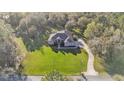 Expansive property with an aerial view of a well-maintained home, lush greenery, and a winding driveway at 9216 Tom Moore Rd, Lakeland, FL 33810