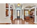 Grand foyer featuring elegant columns, a decorative front door, and beautiful hardwood flooring at 9216 Tom Moore Rd, Lakeland, FL 33810