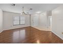 Open living room featuring hardwood floors, a ceiling fan, and a bright front door at 1064 Penguin Pl, Lakeland, FL 33809