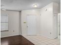 A bright living room with hardwood floors and a front door with adjacent closet at 1064 Penguin Pl, Lakeland, FL 33809