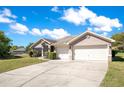 Charming single-story home featuring a two-car garage, well-manicured lawn, and delightful landscaping at 107 Amber Blvd, Auburndale, FL 33823