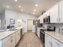 Modern kitchen featuring stainless steel appliances, white cabinets, and an eat-in breakfast bar at 1123 Aruba Ave, Mulberry, FL 33860