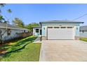 Charming single-Gathering home features an attached two-car garage and a well-maintained lawn at 127 Florida Dr, Winter Haven, FL 33881