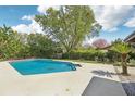 Inviting backyard pool with a concrete deck, perfect for relaxation and enjoying the outdoors at 1722 High Point Dr, Lakeland, FL 33813