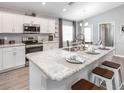 A modern kitchen featuring stainless steel appliances, sleek countertops, and a breakfast bar with stools at 1740 Burrows Ave, Lakeland, FL 33811