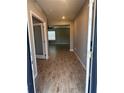 View of the entryway showcasing wood-style tiled flooring, leading to a naturally lit living space at 1921 Bell Creek Loop, Fruitland Park, FL 34731