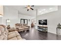 Bright living room featuring high ceilings, dark floors and an open layout at 2030 Country Manor St, Bartow, FL 33830