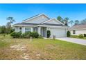 Inviting single-story home with manicured lawn and an attached two-car garage at 2085 Pecos Dr, Kissimmee, FL 34759