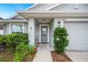 Cozy front entrance with a tiled walkway, well-kept garden and an attached two-car garage at 2085 Pecos Dr, Kissimmee, FL 34759