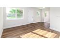 Bright living room featuring wood flooring, a white interior, and large windows for ample natural light at 2924 Bellwood Ave, Lakeland, FL 33803