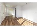 Bright living room featuring wood flooring, a white interior, and large windows for ample natural light at 2924 Bellwood Ave, Lakeland, FL 33803