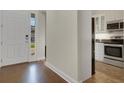 Bright foyer featuring hardwood floors with view of the kitchen area at 2987 Mission Lakes Dr # 10, Lakeland, FL 33803