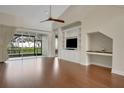 Living room featuring vaulted ceiling, hardwood floors, and built in shelving at 2987 Mission Lakes Dr # 10, Lakeland, FL 33803