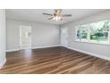 Spacious living room featuring attractive vinyl floors, a ceiling fan and natural light at 300 Senate St, Auburndale, FL 33823