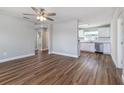 Bright living room with hardwood floors flowing into an updated kitchen with stainless appliances at 300 Senate St, Auburndale, FL 33823