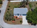 Aerial view of a well-kept single-story home with a manicured lawn, vibrant landscaping, and a spacious driveway at 3166 Valley Vista Cir, Lakeland, FL 33812