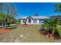 Inviting single-story home showcasing a well-maintained lawn, palm trees, colorful mulch, and a cozy, residential atmosphere at 3166 Valley Vista Cir, Lakeland, FL 33812