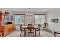 Inviting dining area with wood table set, chandelier, and sunlit windows at 3717 Highland Fairways Blvd, Lakeland, FL 33810