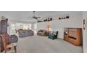 Spacious living room featuring neutral carpet, ceiling fan, and natural light at 3717 Highland Fairways Blvd, Lakeland, FL 33810