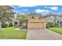 Charming home with a two-car garage, stone accents, and a beautifully paved driveway and walkway at 4759 Lathloa Loop, Lakeland, FL 33811