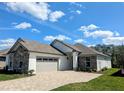 Charming home featuring a three-car garage and paved driveway leading up to the residence at 7903 Lake James Blvd, Lakeland, FL 33810