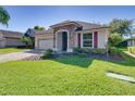 Well-maintained single Gathering home with manicured lawn, brick accents, shutters, and paved driveway at 8160 Lake James Dr, Lakeland, FL 33810